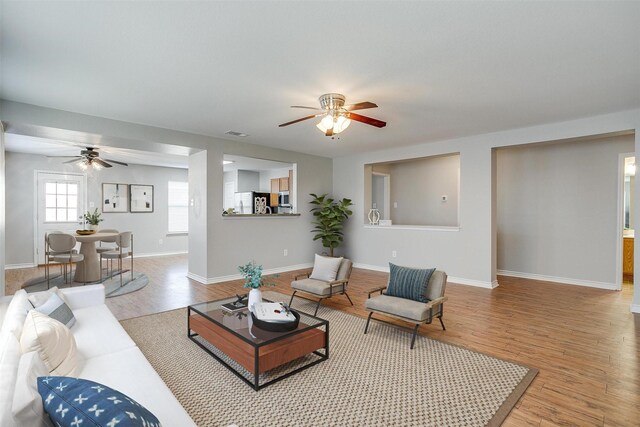 unfurnished living room featuring hardwood / wood-style floors and ceiling fan