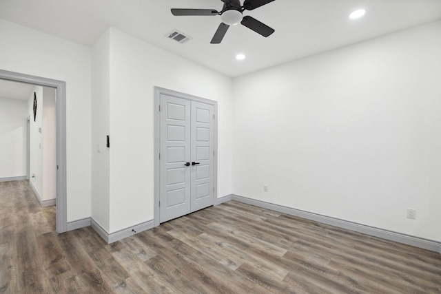 unfurnished bedroom with wood-type flooring and ceiling fan