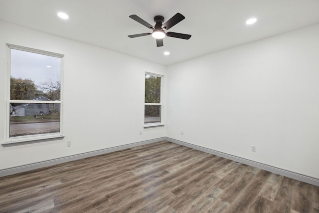 spare room with hardwood / wood-style floors and ceiling fan