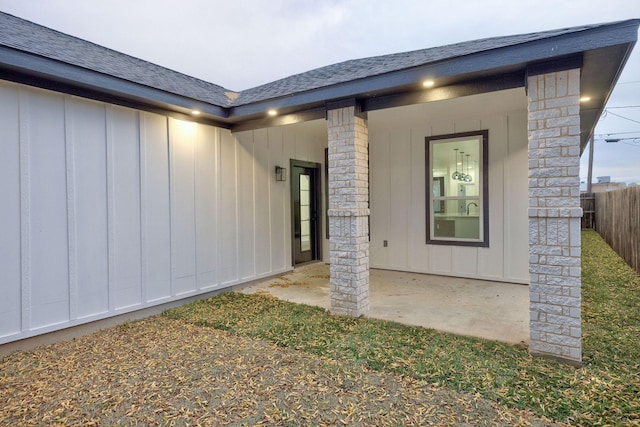 view of exterior entry featuring a patio area