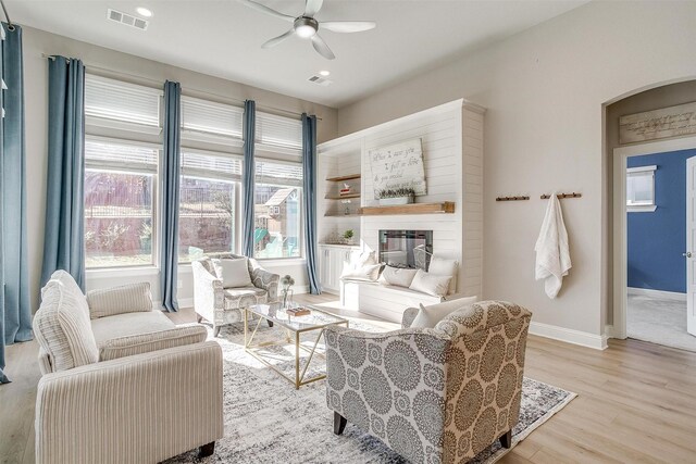 living room featuring ceiling fan and light hardwood / wood-style flooring