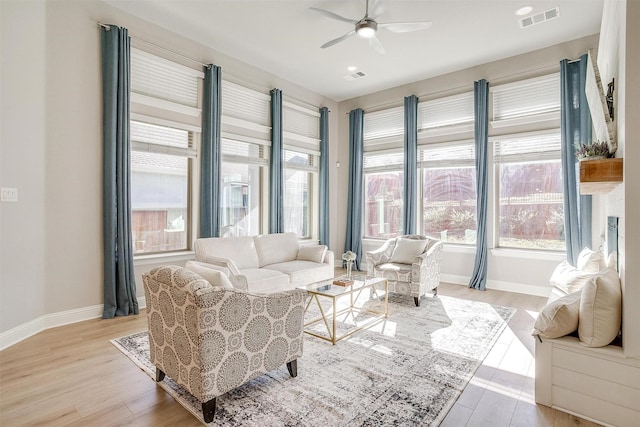 living room featuring light wood-type flooring and ceiling fan