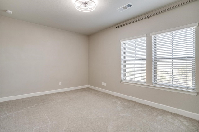 spare room featuring light carpet