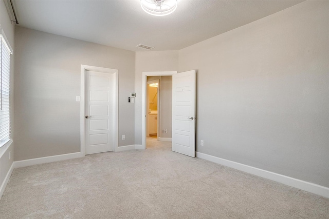 unfurnished bedroom with light colored carpet