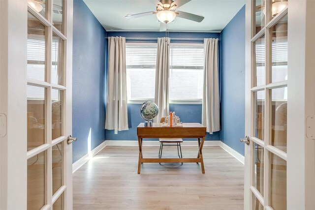 office featuring ceiling fan, french doors, and light hardwood / wood-style flooring