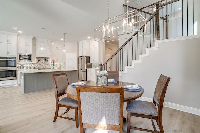 dining area featuring a chandelier and light hardwood / wood-style floors