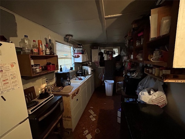 kitchen featuring sink, white cabinets, white refrigerator, hanging light fixtures, and electric stove