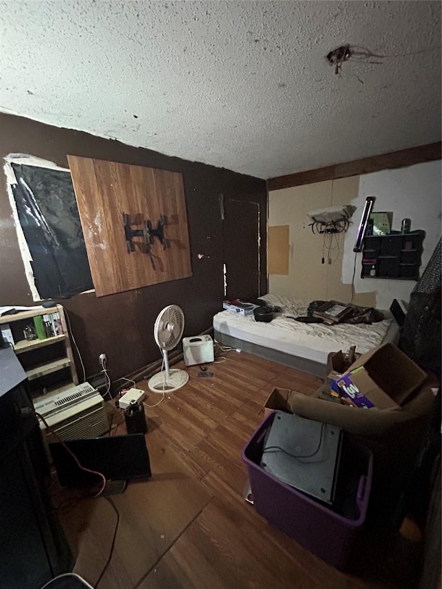 interior space with a textured ceiling and hardwood / wood-style flooring