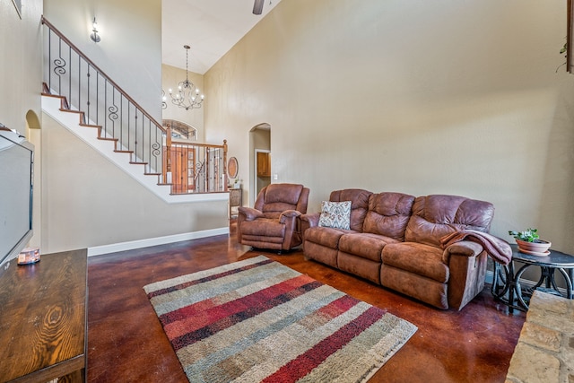 living room with a notable chandelier and high vaulted ceiling