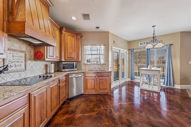 kitchen featuring pendant lighting, backsplash, premium range hood, an inviting chandelier, and appliances with stainless steel finishes