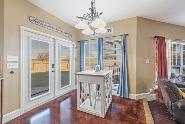 dining room with french doors and a notable chandelier