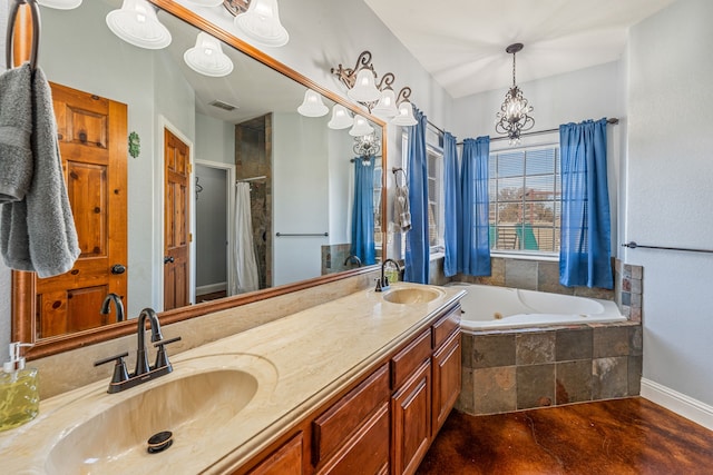 bathroom featuring vanity, a notable chandelier, and shower with separate bathtub