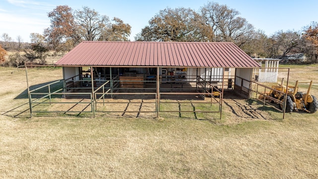 view of horse barn with a rural view