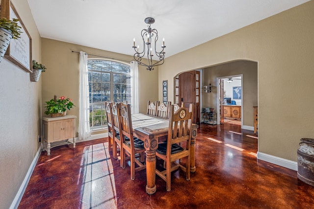 dining room featuring ceiling fan with notable chandelier