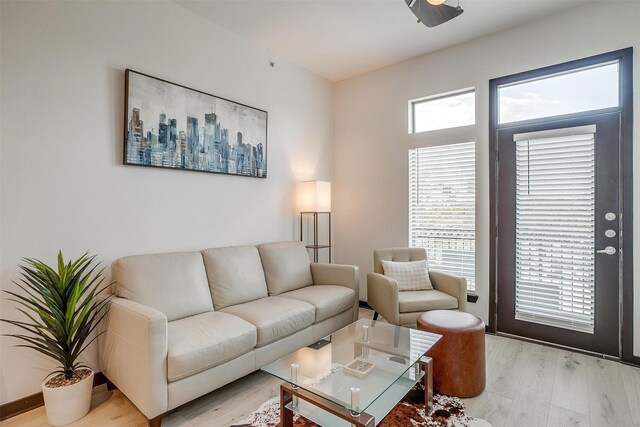 living room featuring light hardwood / wood-style floors and ceiling fan