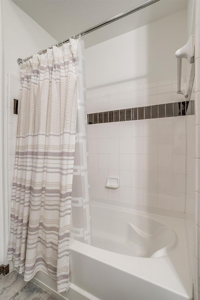 bathroom featuring shower / bath combo with shower curtain