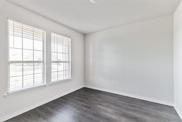 spare room with dark wood-type flooring