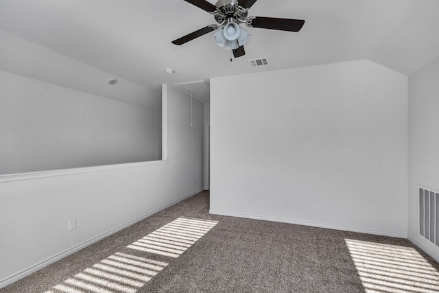 bonus room featuring ceiling fan, dark carpet, and lofted ceiling