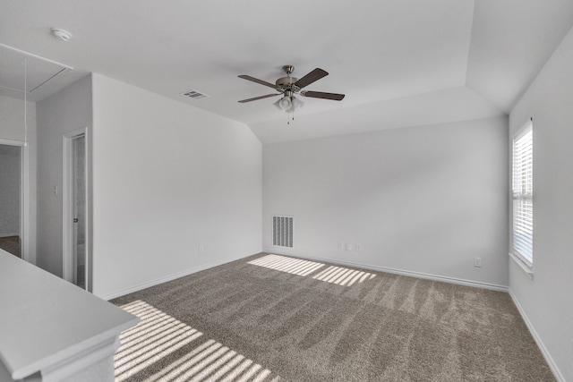 unfurnished living room with ceiling fan, carpet floors, and vaulted ceiling