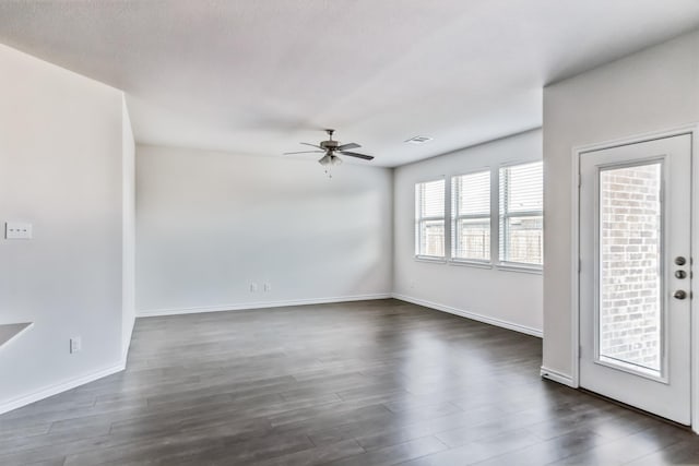 unfurnished room with ceiling fan and dark hardwood / wood-style flooring