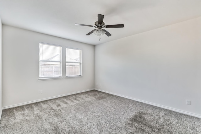 empty room featuring ceiling fan and light carpet