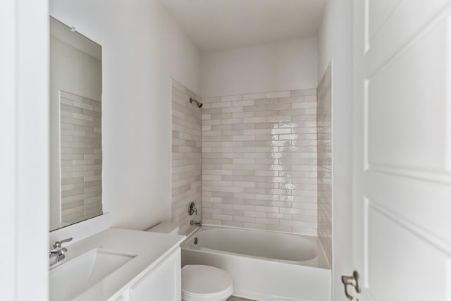 full bathroom with vanity, toilet, and tiled shower / bath