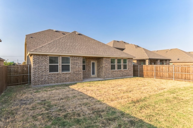 back of property featuring a lawn