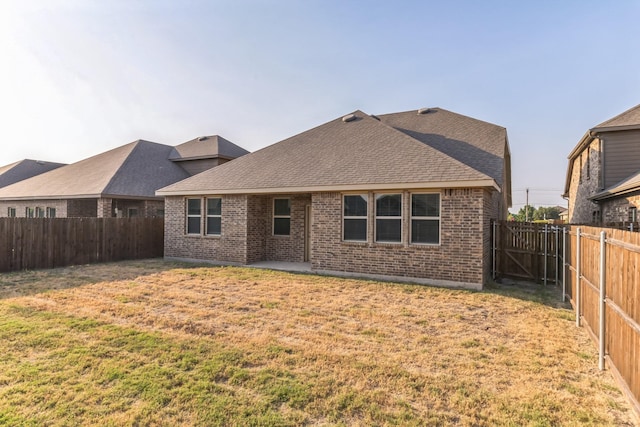 rear view of property with a lawn