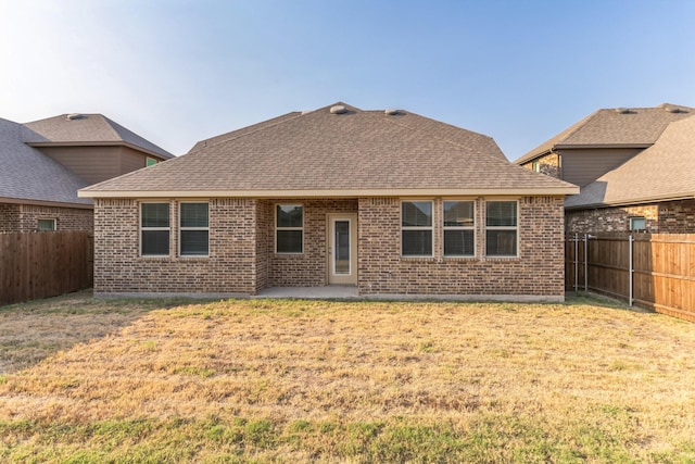 rear view of property with a lawn and a patio area