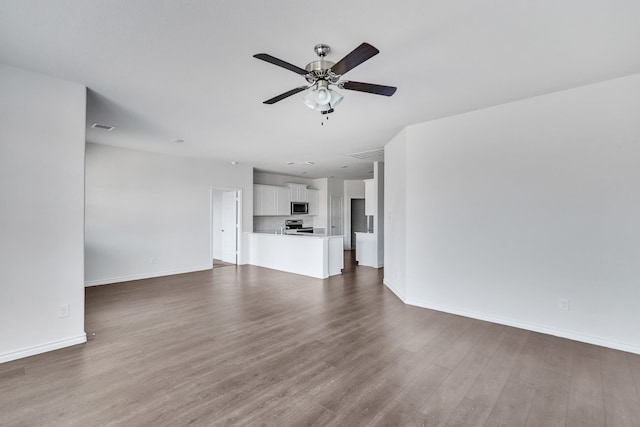 unfurnished living room featuring ceiling fan and wood-type flooring