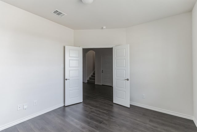 unfurnished room featuring dark hardwood / wood-style floors