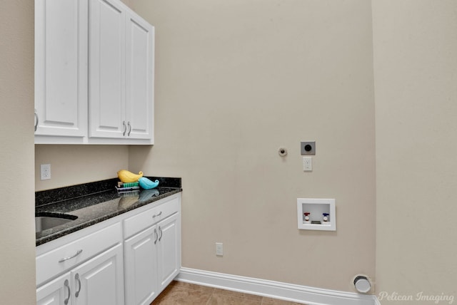 washroom with sink, cabinets, washer hookup, hookup for an electric dryer, and light tile patterned floors