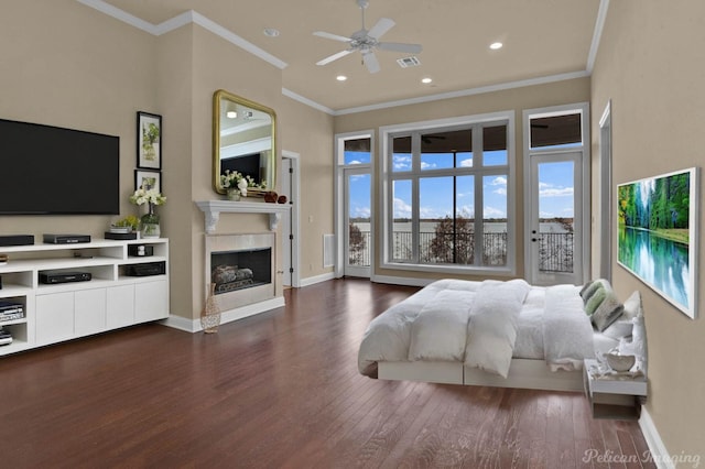 bedroom featuring ceiling fan, dark hardwood / wood-style flooring, crown molding, a towering ceiling, and access to outside