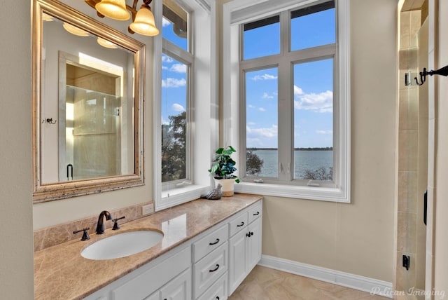 bathroom with vanity, a healthy amount of sunlight, and a water view