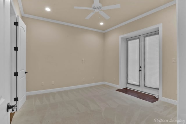 unfurnished room with ceiling fan, french doors, light colored carpet, and ornamental molding