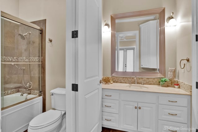 full bathroom with vanity, toilet, and enclosed tub / shower combo