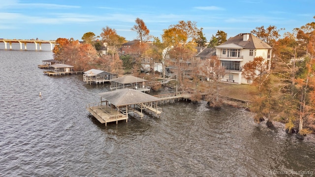 view of dock featuring a water view and a balcony