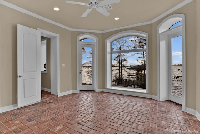 empty room featuring crown molding and ceiling fan