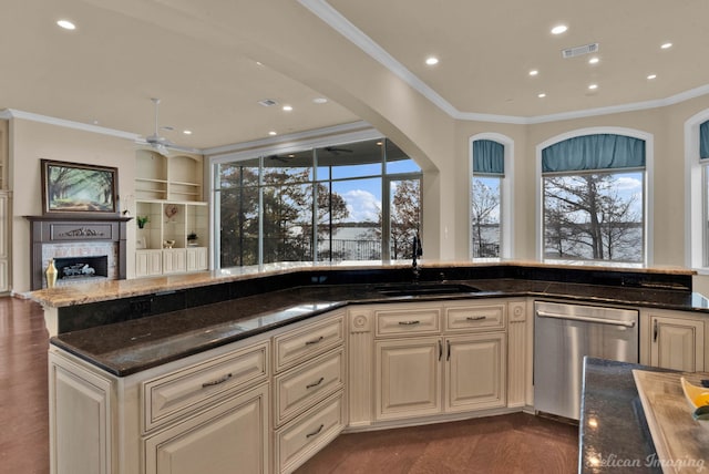 kitchen featuring dark hardwood / wood-style floors, dishwasher, sink, dark stone countertops, and crown molding