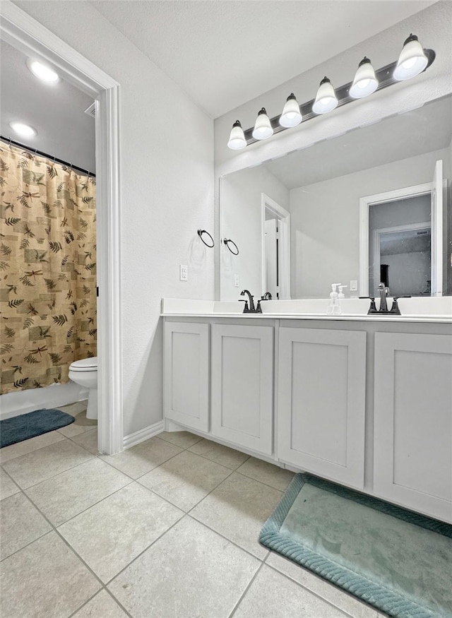 full bathroom featuring toilet, vanity, tile patterned floors, and shower / bathtub combination with curtain