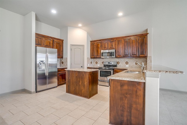 kitchen featuring backsplash, sink, vaulted ceiling, kitchen peninsula, and stainless steel appliances