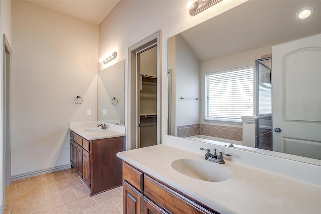 bathroom with tile patterned floors, vanity, and a bath