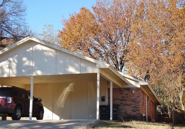 view of side of home with a carport