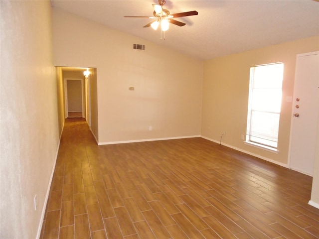 unfurnished room featuring ceiling fan, dark hardwood / wood-style flooring, and vaulted ceiling