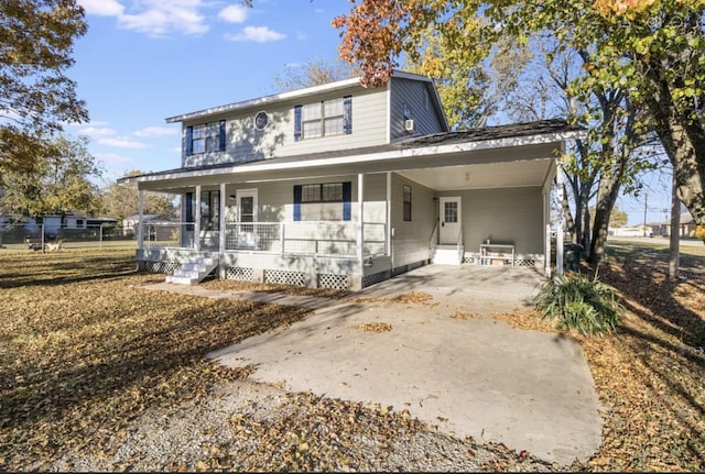 rear view of house featuring a carport and covered porch