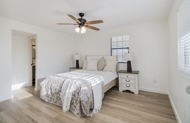 bedroom with ceiling fan and light hardwood / wood-style floors