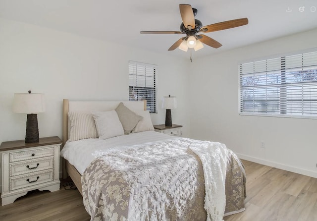 bedroom with ceiling fan and light hardwood / wood-style floors