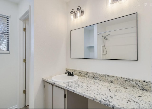 bathroom with vanity and walk in shower