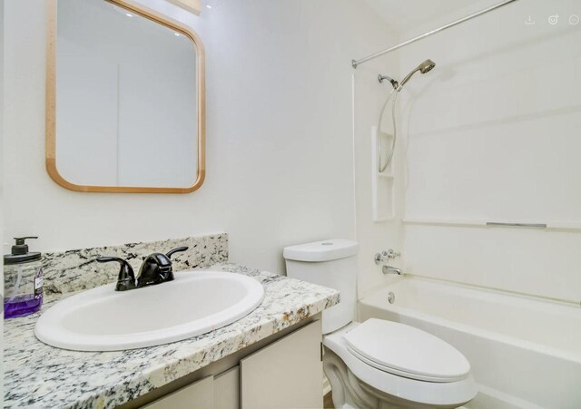 full bathroom featuring shower / bathing tub combination, vanity, and toilet