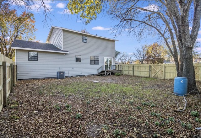 rear view of property with central AC